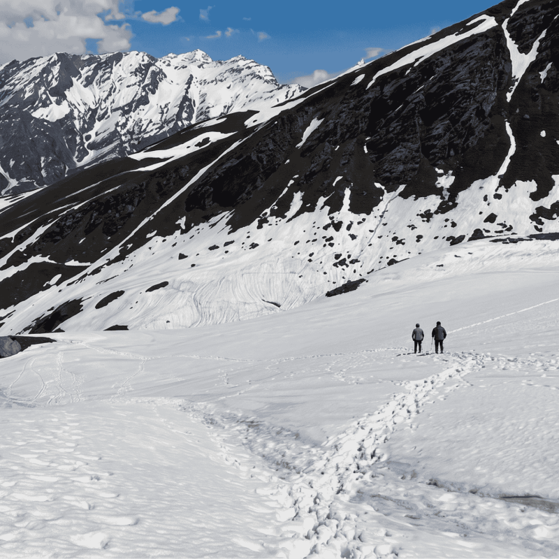 Clear blue skies and snow-covered peaks at Bhrigu Lake in May